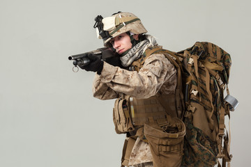 Soldier in camouflage holding rifle