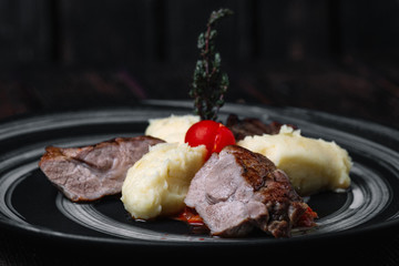 Grilled beef steak with mushed potato on wooden background