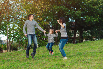 Fototapeta premium happy young family spending time together in park