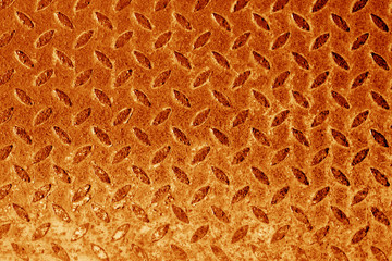 Diamond shaped metal floor pattern in orange tone.