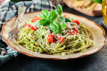 Vegetarian pasta spaghetti with basil pesto and cherry tomatoes