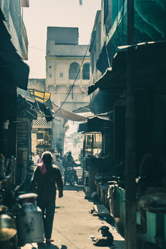 narrow alley and street food in Pushkar, India, teal toned image.