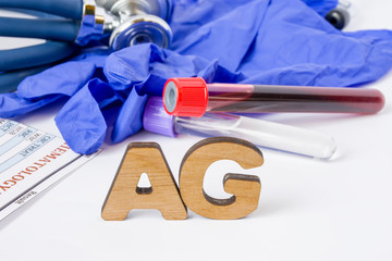 AG Medical laboratory acronym or abbreviation of antigen, immune response component, piece and immune system. Letters AG are near laboratory test tubes with blood sample, stethoscope, protection glove - obrazy, fototapety, plakaty