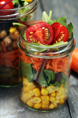 Homemade salad in glass jar with vegetables. Healthy food, diet, detox and clean eating