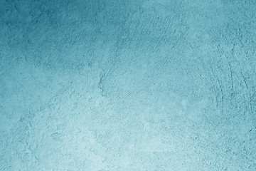 Plaster wall texture in cyan color.
