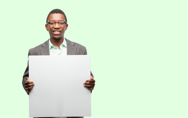 African black man wearing jacket holding blank advertising banner, good poster for ad, offer or announcement, big paper billboard