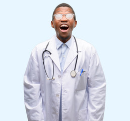 Fototapeta premium Young black doctor, medical professional stressful, terrified in panic, shouting exasperated and frustrated. Unpleasant gesture. Annoying work drives me crazy