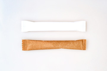 Brown and white paper sachets isolated on white background