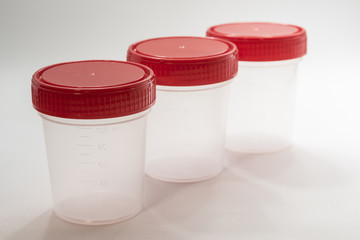 Jars for medical tests on a white background