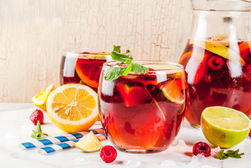 Summer cold cocktail, fruit and berry red wine sangria with apple, lemon, oranges and raspberry. light b