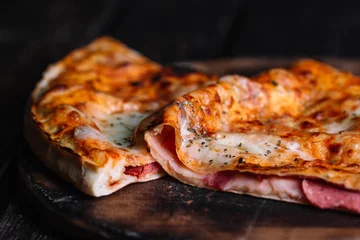 Papier Peint photo Lavable Pizzeria Cutted Calzone - Stuffed Pizza with Tomato, Mozzarella and Ham