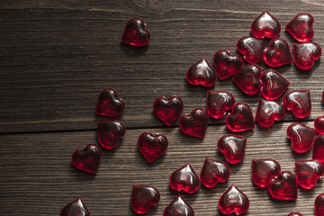  Red hearts on a brown wooden background