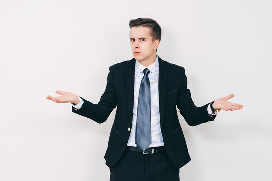 Young business man having a doubt. Closeup portrait of clueless young man in suit. Skeptic, unsure, uncertain, doubts concept.