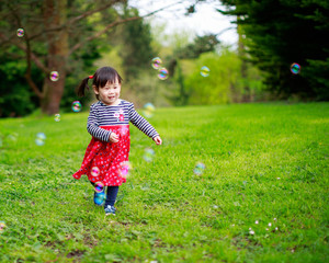 baby girl play bubble at spring garden