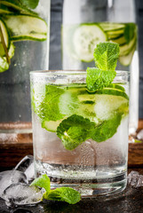 Summer fresh iced drink, mint and cucumber infused water, summer healthy detox mojito cocktail, light background copy space