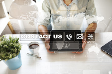 Contact us button and text on virtual screen. Business and technology concept.