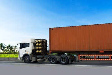 Truck on highway road with red container, transportation concept.,import,export logistic industrial Transporting Land transport on the asphalt expressway with blue sky