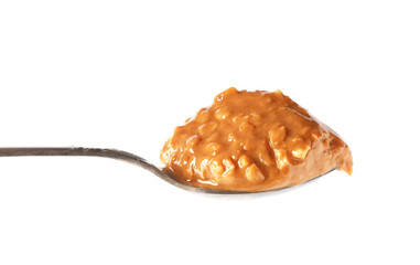 spoon of peanut butter on white background