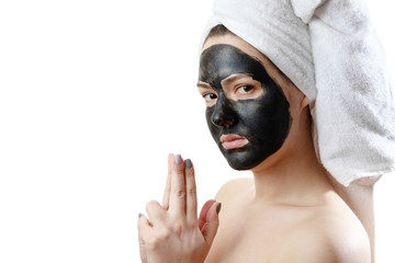 beautiful sexy girl with black face mask on the white background,  close-up portrait, isolated, girl with a towel on her head, black mask on girl's face, is indulging, like a criminal