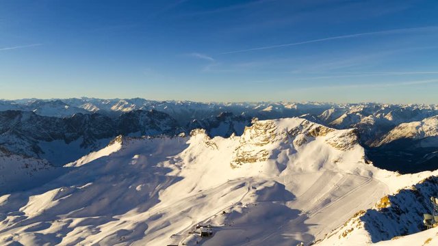 Time Lapse view of the glaciers on top of Germany's tallest mountain, the Zugspitze, with the Zugspitz skiing resort on a beautiful cloudless winter morning.