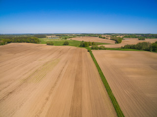 Fototapeta na wymiar aerial view of freshly plowed agricultural fields ready to sowing