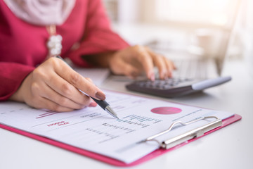 Woman hands working with calculator about personal financial planning at cafe.