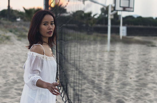 Indonesian woman with white lightweight beach lifestyle dress