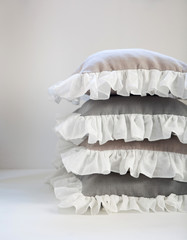 Romantic ruffled linen pillows stack isolated on white