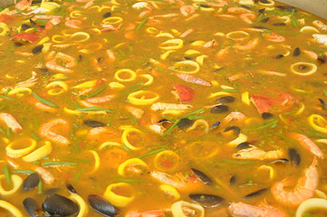 Preparation of a gigantic paella with seafood 060