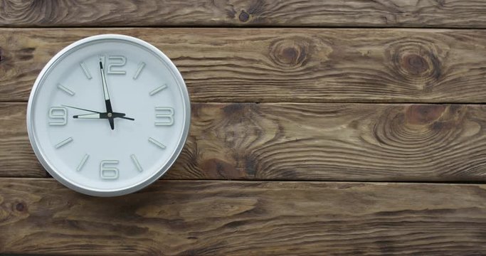 Timelapse of Clocks Showing Nine. Timelapse of clocks showing 9 o'clock. Breat wooden background for your text