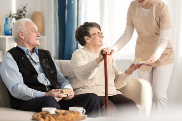 Geriatric couple with arthritis sitting