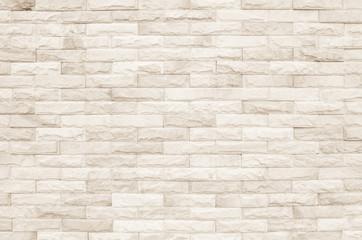 Cream and white brick wall texture background. Brickwork or stonework flooring interior rock old pattern clean concrete grid uneven bricks design stack.