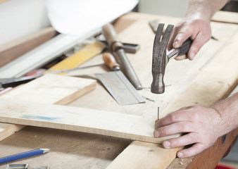 carpeter hammering nail.copy space