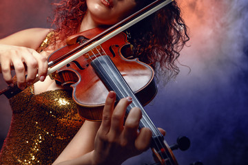 Violinist girl performs on stage.