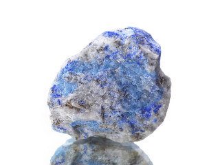 macro shooting of natural mineral rock specimen -  lapis lazuli stone on an isolated white background,reflection