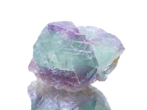 macro shooting of natural mineral rock specimen -  fluorite stone on an isolated white background,reflection