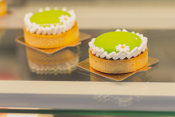 Delicious cream cake on the store counter. Food