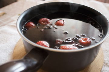 compote with berries in the ladle