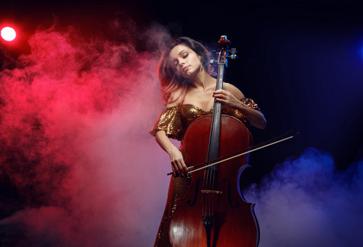 The cellist girl performs on stage.