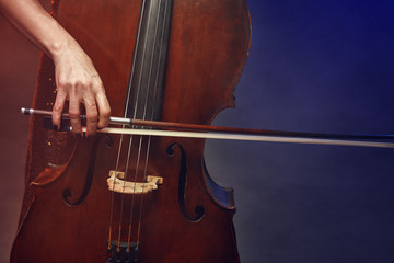 The cellist girl performs on stage.