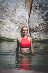 Obraz premium Sexy blond female fitness model posing on the beach with a sexy bikini