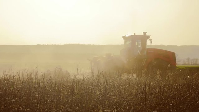Farmer in tractor Russia agriculture soil ground preparing land with seedbed cultivator as part of pre seeding activities in lifestyle early spring season of agricultural works at farmlands