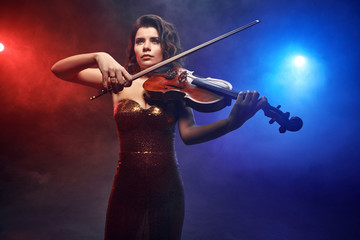 Violinist girl performs on stage.