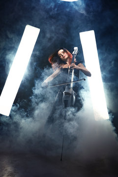 The cellist girl performs on stage.