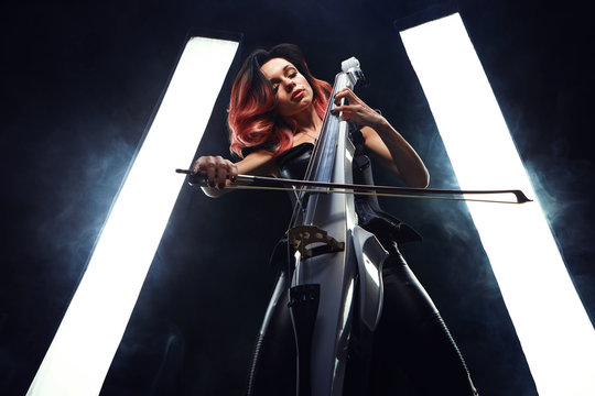 The cellist girl performs on stage.