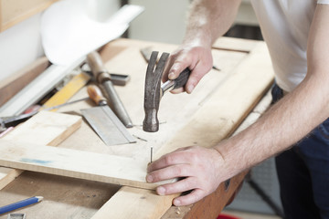 carpeter hammering nail.copy space