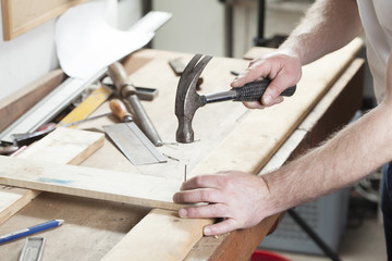 carpeter hammering nail.copy space