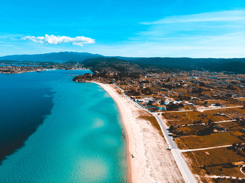 island at greece with big beach and clear blue and green water