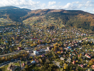 Aerial autumn top view of the Carpathian village at sunny day