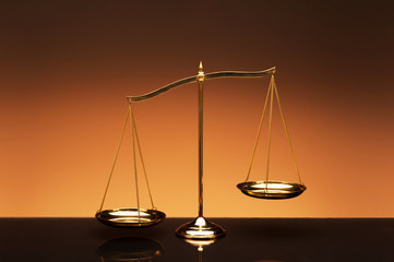 Balance scale on orange color background